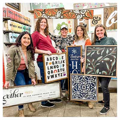 Group photo of guests with their wood signs